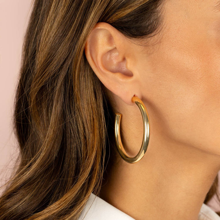 Large hollow gold hoop best sale earrings